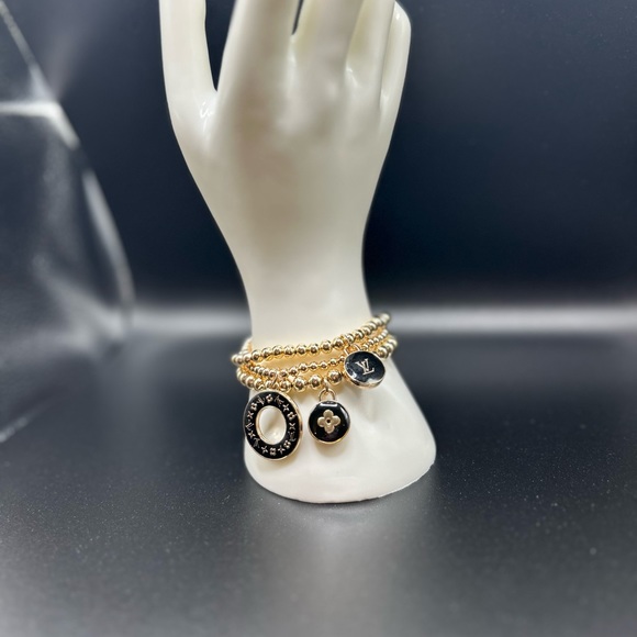 3 LV zipper pull charms on a 3 set gold color stretchable brac… - Picture 3 of 5